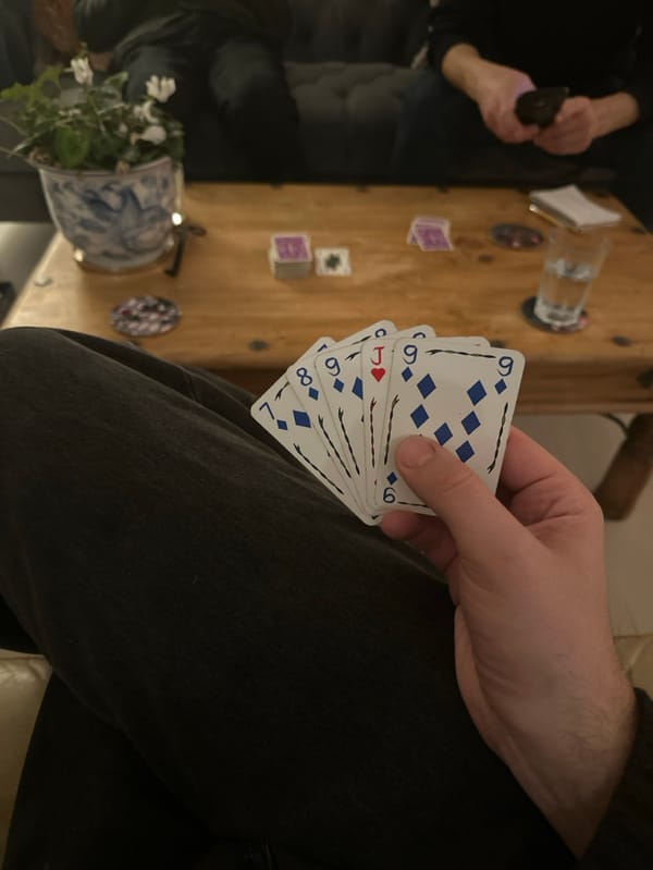 Card player holds hand with jack, diamonds in West Suffolk