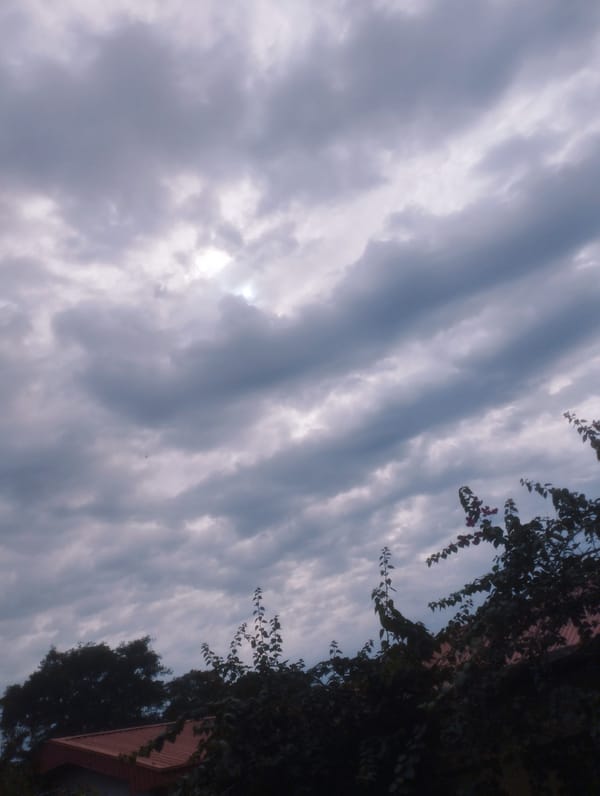 Morning street scenes under cloudy skies in Jos, Nigeria