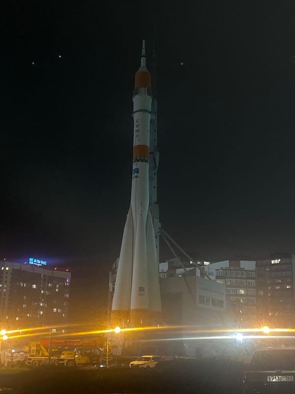 Soyuz rocket monument illuminated at night in Novokuybyshevsk