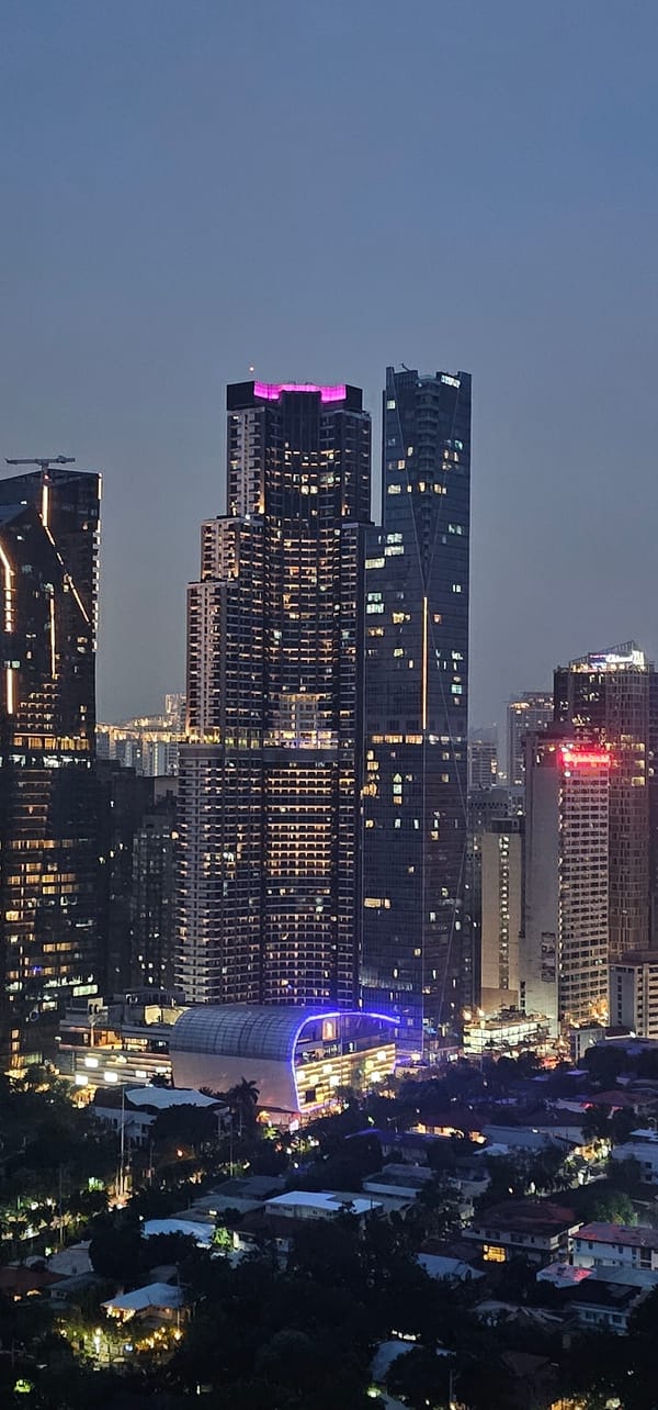 Makati at night: skyline, traffic, and Ayala Malls Circuit