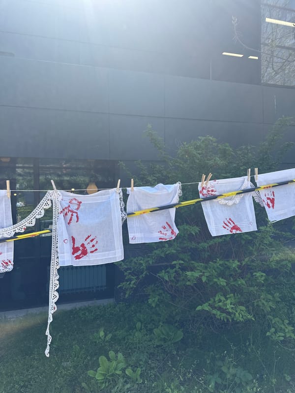 Handprint-decorated handkerchiefs displayed on pole in Sofia
