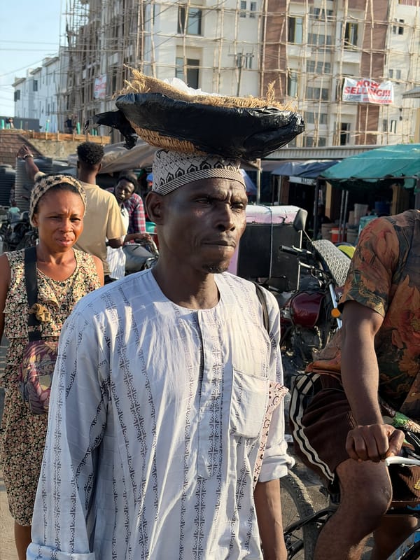 Daily life scenes documented in Igboefon, Nigeria include damaged vehicle