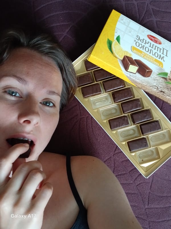 Woman enjoys Russian chocolates during morning treat in Yekaterinburg