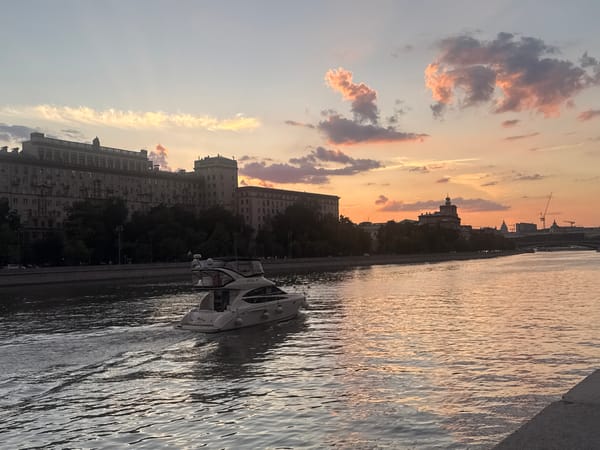 Sunset over the Moskva River, cyclists and skyline in frame