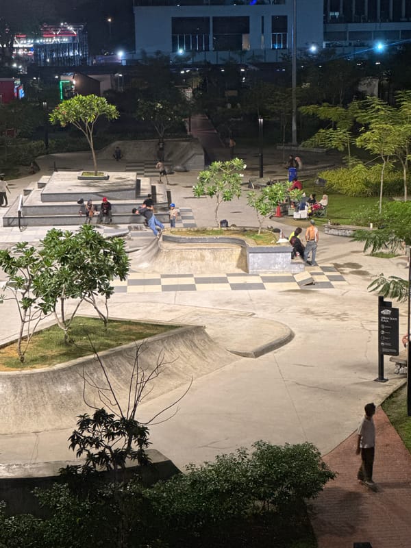 Nighttime skating activity documented at illuminated Kuala Lumpur urban plaza