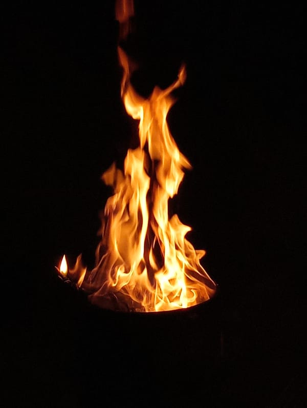 Metal barrel fire burning at night in Shymkent