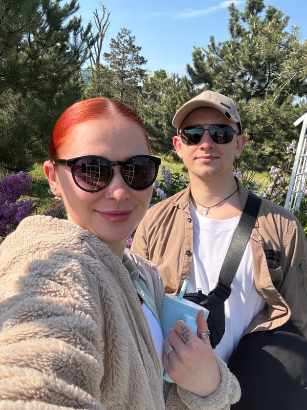 Couple photographs spring blooms and riverfront during Rostov-on-Don outing