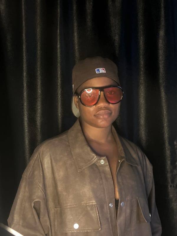 Brown jacket, MLB cap, red shades — multiple angles in Badagry