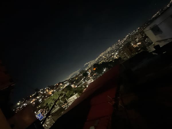 Night photography captures Caracas city lights beneath mountains