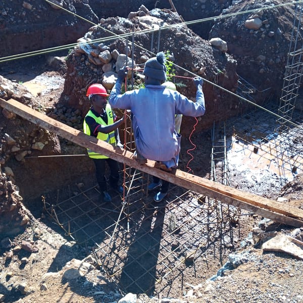 Construction workers build foundation in Borabu Chitago ward
