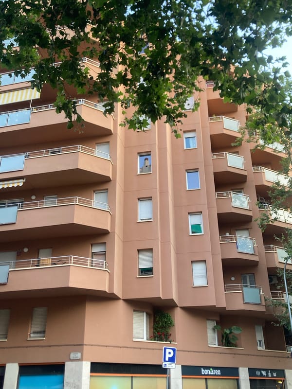 Barcelona apartment blocks and a shuttered cafeteria at street level