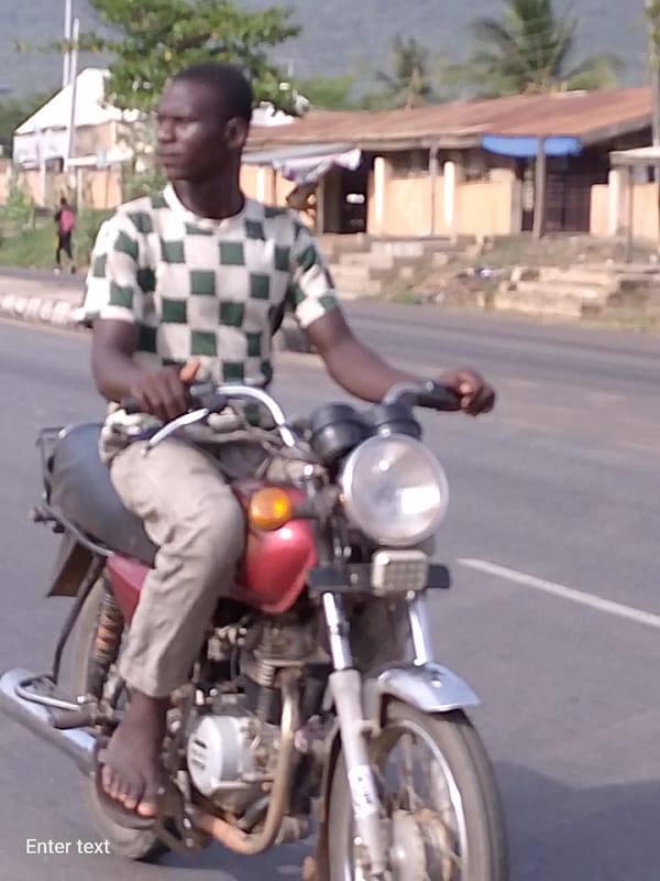 Routine street traffic documented in Adankolo, Nigeria Sunday afternoon