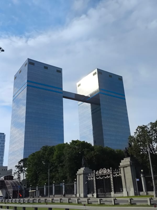 Glass towers, dealerships, and cranes define a growing commercial district