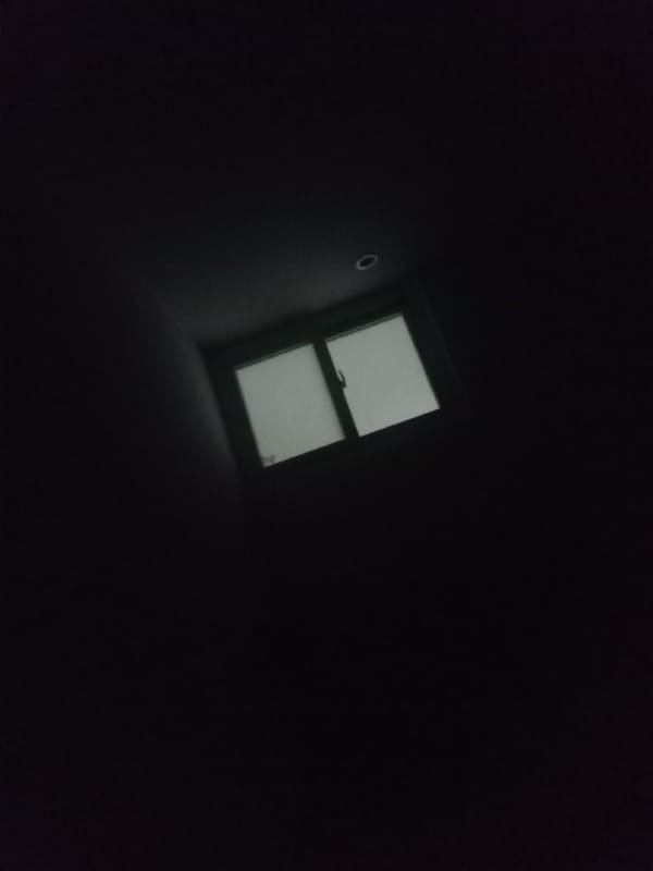 Dimly lit room and device screen captured in nighttime memories