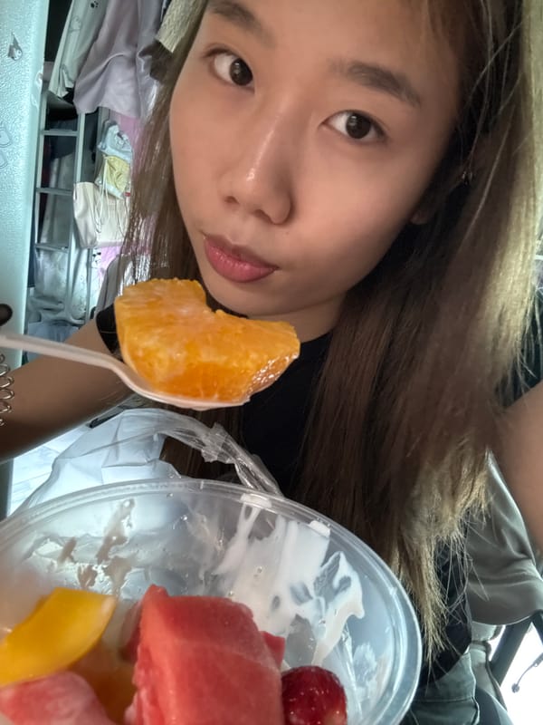 Person shares orange from fruit container in Nan'an District