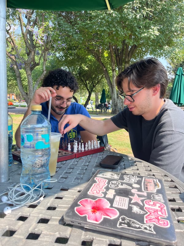 Two men play chess outdoors in San Andrés Cholula