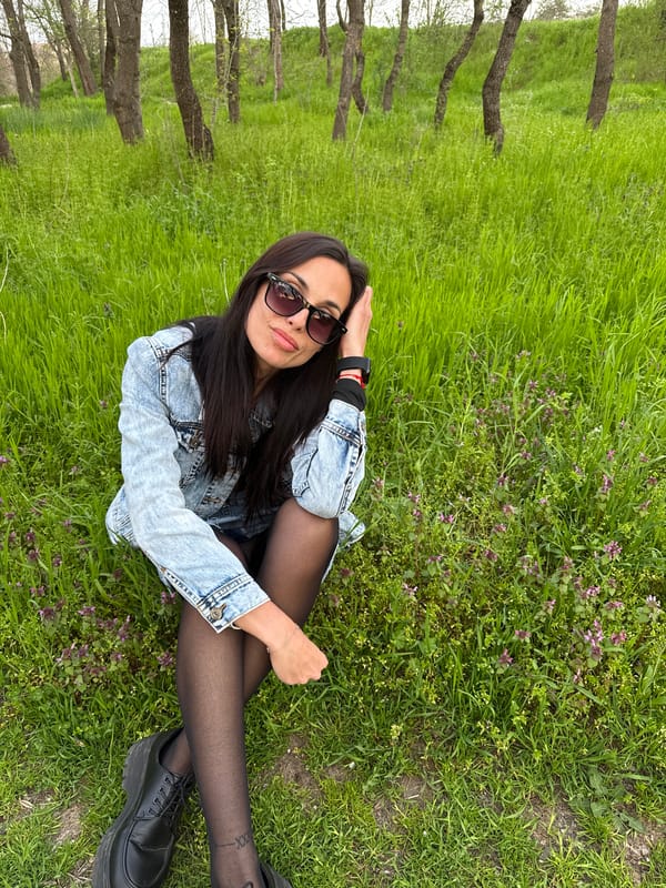Woman photographed with flower bouquet in Pleven park setting