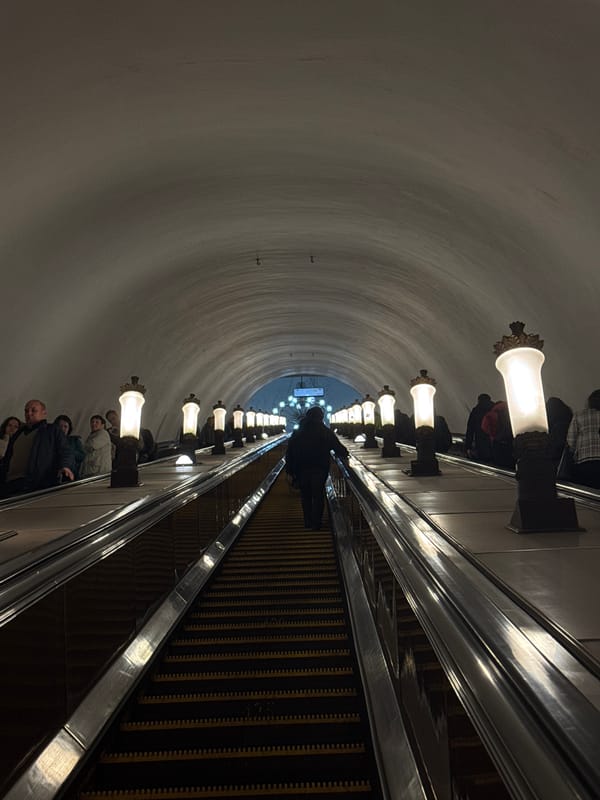 Moscow metro station captured with escalator passengers, star mosaic
