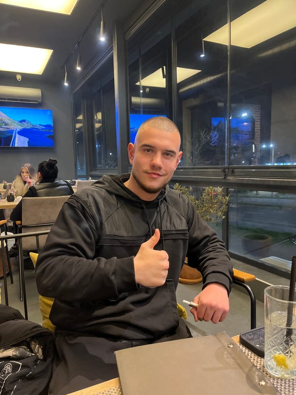 Two men socialize at Burgas cafe Friday evening