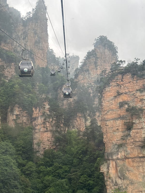 Cable cars operate through foggy mountains in Wulingyuan, China