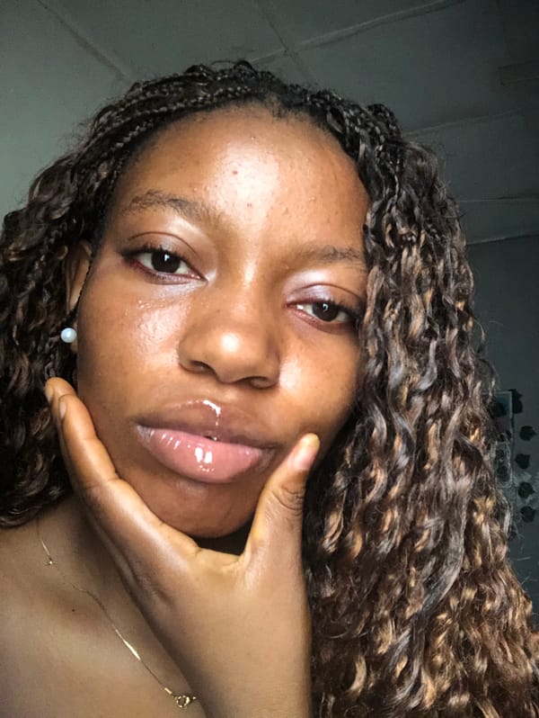 Young woman takes selfies indoors in Nigeria morning