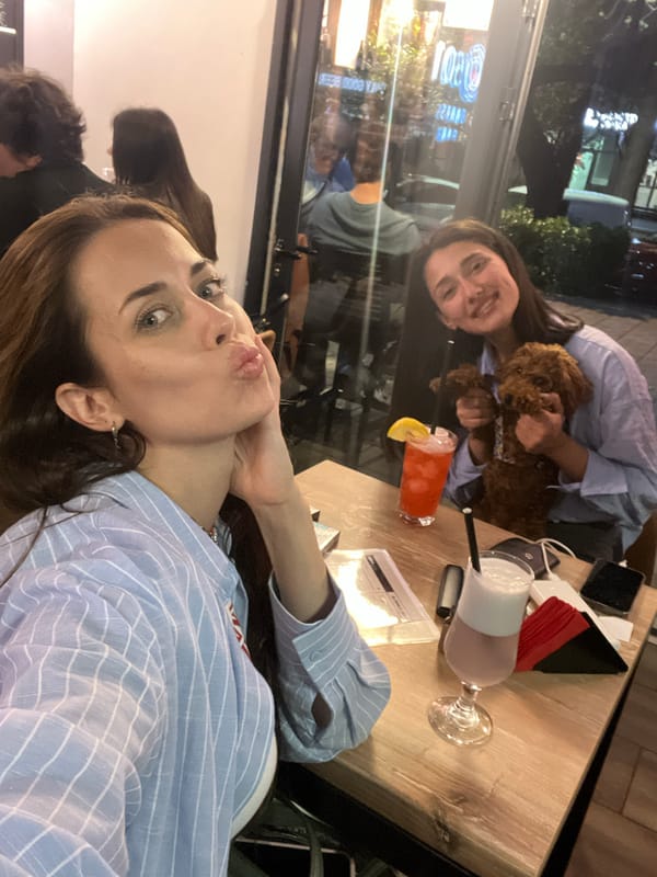 Women photograph with poodle at Montenegro bar