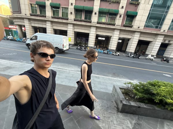 Couple takes selfies on Shanghai street during morning outing