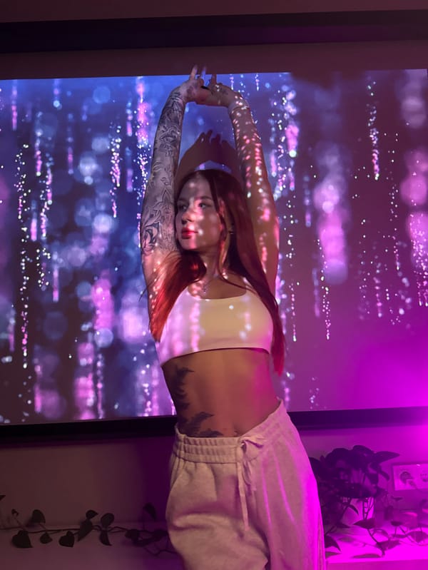 Woman poses with colorful heart projections in Rostov art session