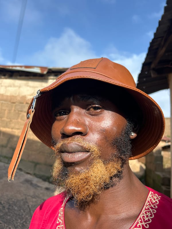 Portraits in Jos: red embroidered garment and bucket hat