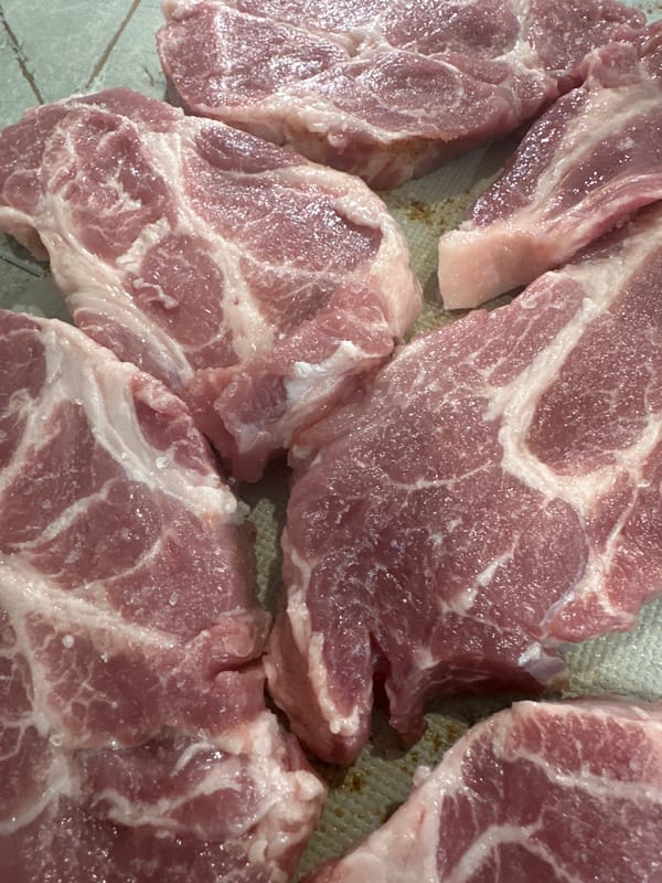 Raw pork cuts seasoned for cooking preparation