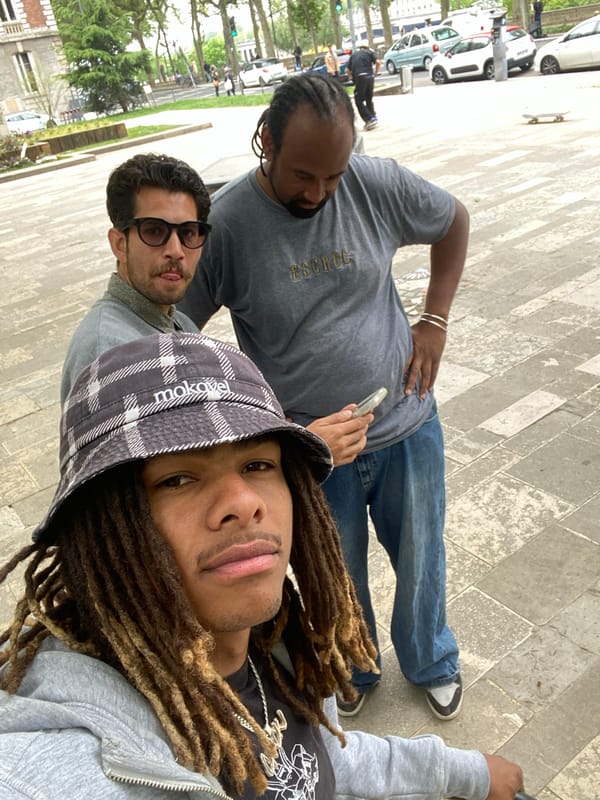 Young men perform stunt scooter tricks in Lyon plaza