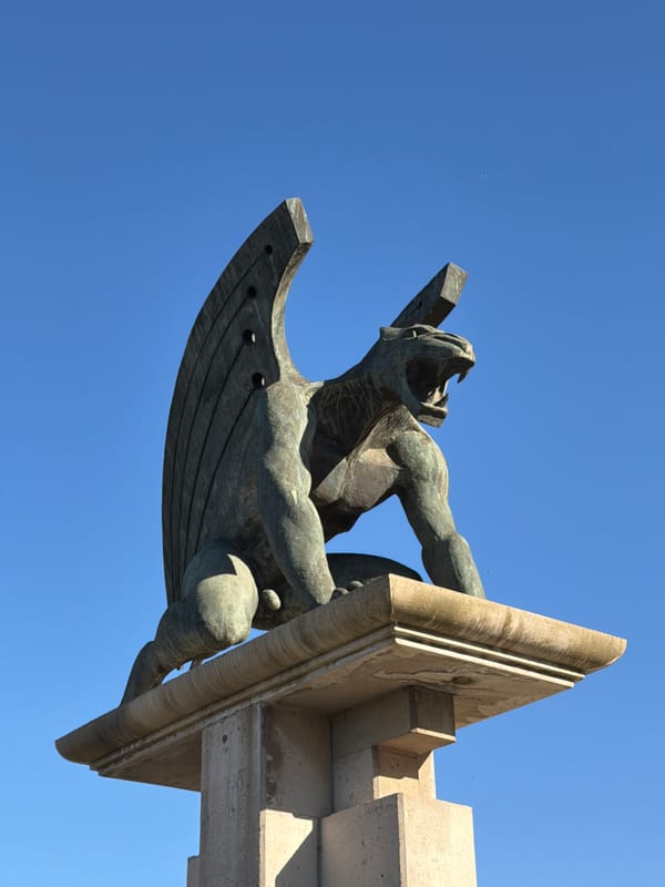 Winged bronze figure sculpture spotted on Valencia stone structure