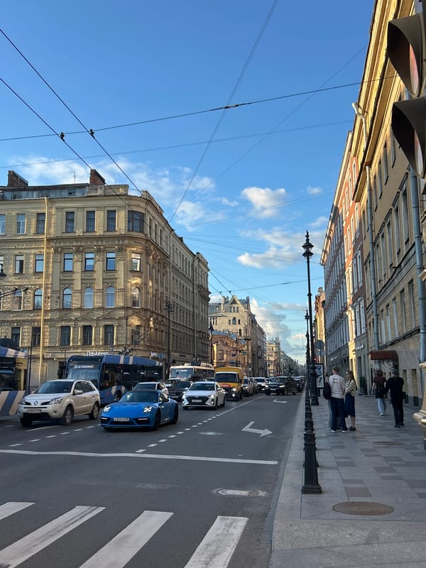 Yellow Lamborghini parked on an ornate European city street
