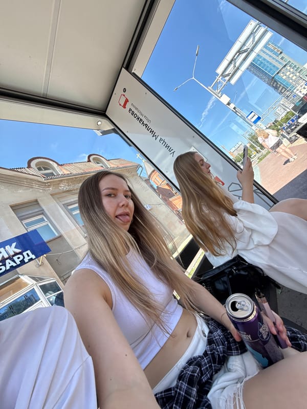 Selfies and downtime at a glass bus stop in Perm