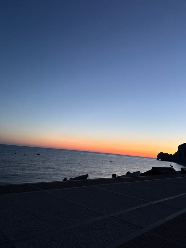 Étretat's chalk cliffs and arch at dawn