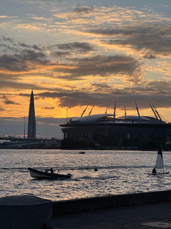 Saint Petersburg skyline at golden hour, clouds over the water