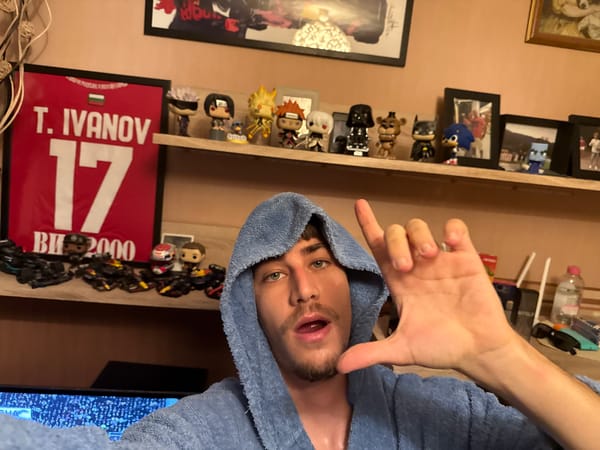 Person in blue towel makes gesture near collectibles shelf