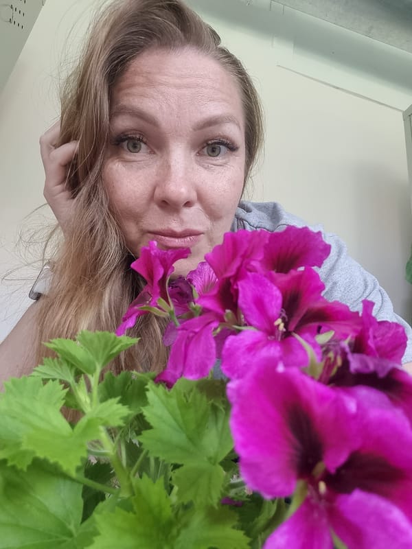 Woman takes flower selfies in Kemul, Russia