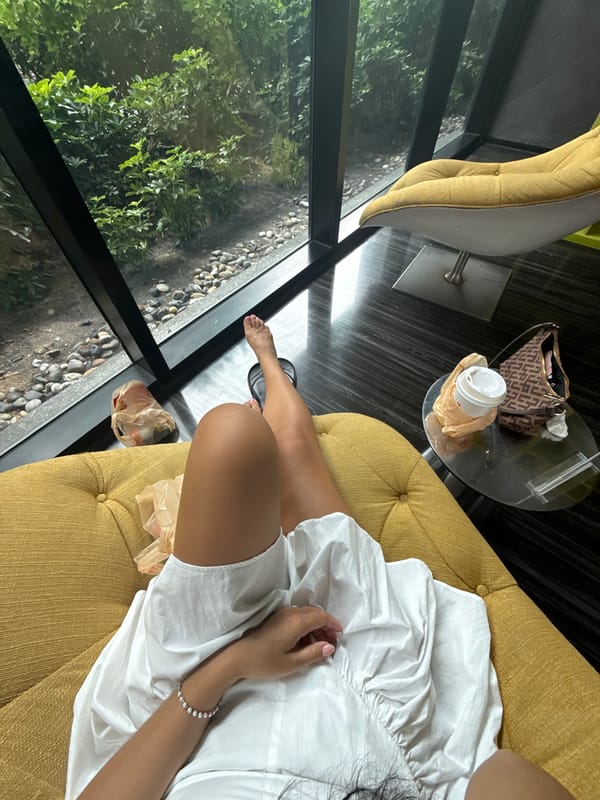 Relaxed pose on a yellow tufted sofa in Pattaya