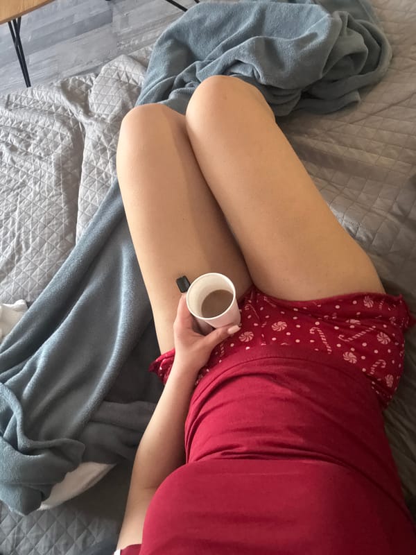 Person relaxes with drink on bed in Varna