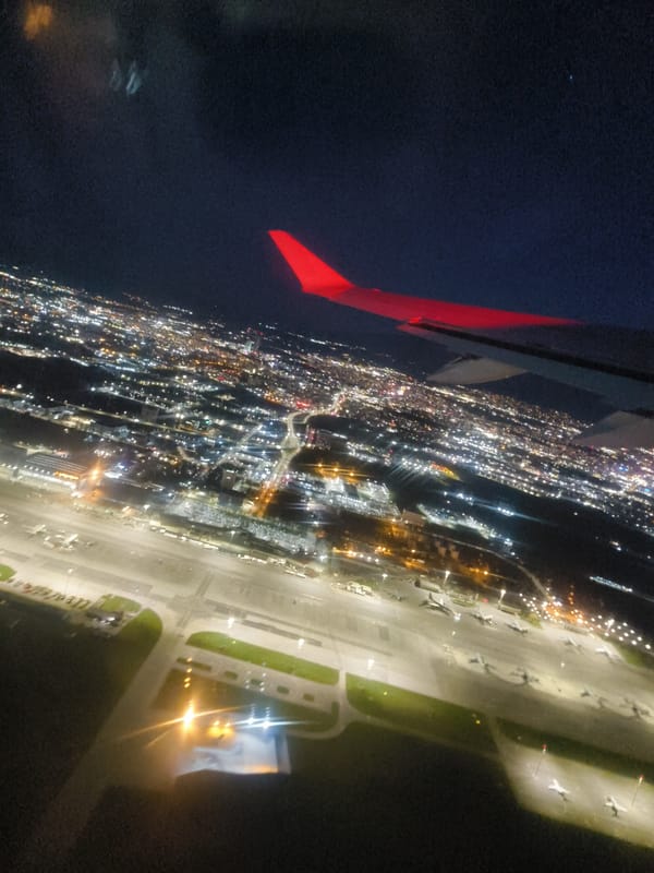 Aircraft wing spotted at dusk over city lights