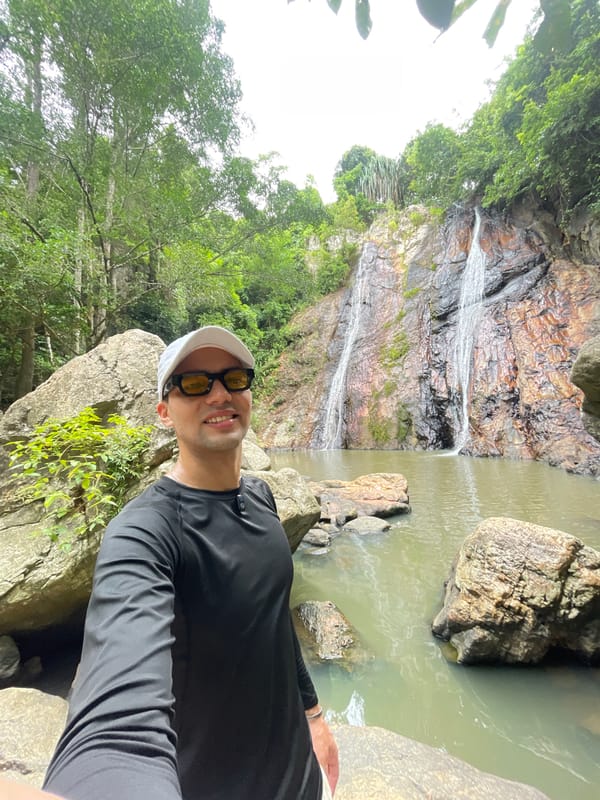 Tourist takes selfie at waterfall in Baan Thurian, Thailand
