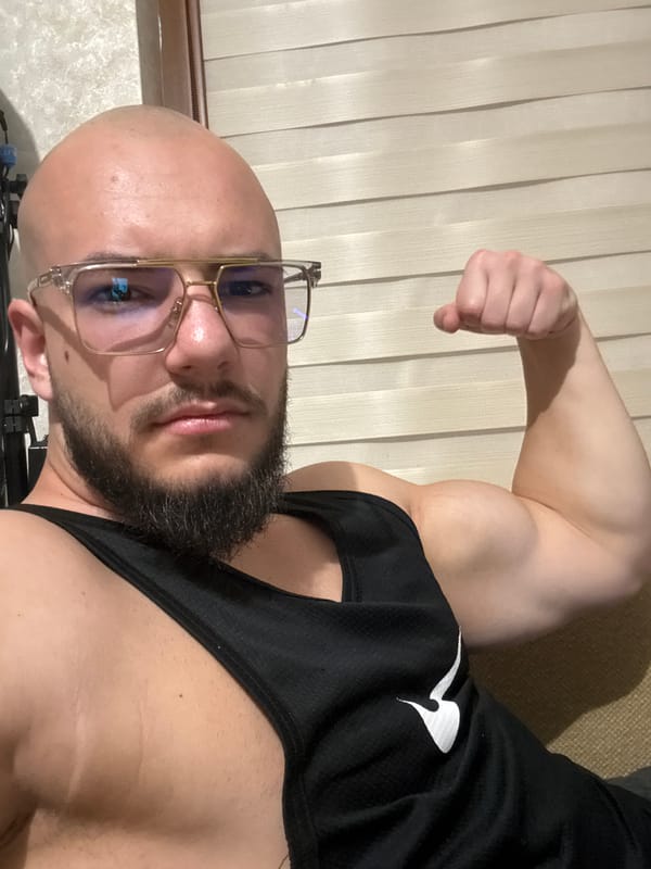 Man flexes arm indoors in Sofia