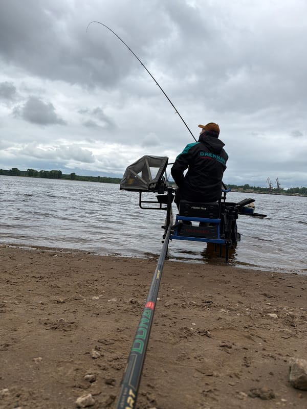 Angler fishes Kama River in overcast Chaikovsky morning