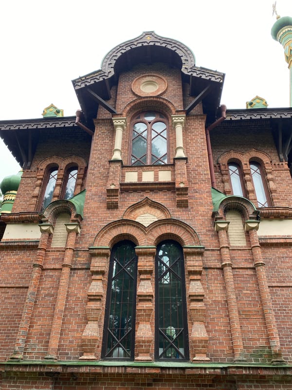 Red-brick Orthodox church with green domes, Priozersk, Russia