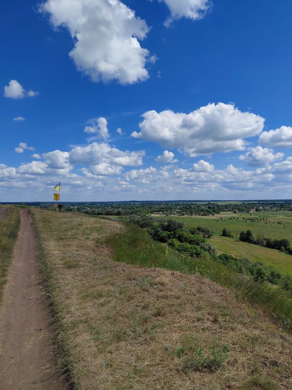 Hilltop viewpoint in rural Ustyvytsia with flag and countryside views