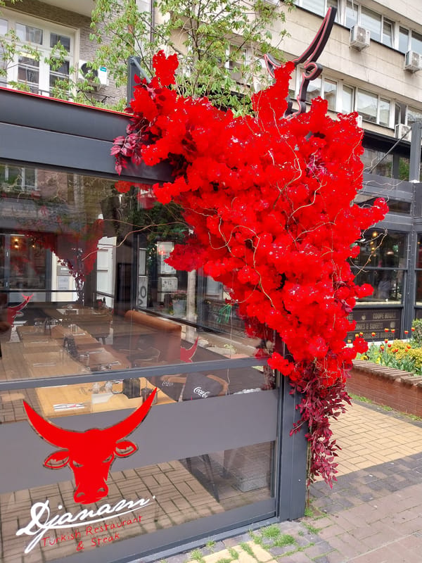 Woman walks past decorated Turkish restaurant entrance