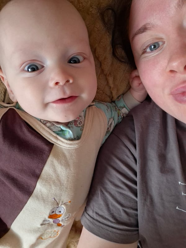 Adult and baby share quiet moment on textured surface