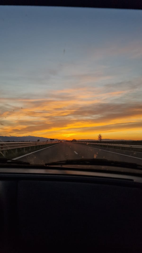 Motorist observes colorful sunset while driving near Malo Konare, Bulgaria