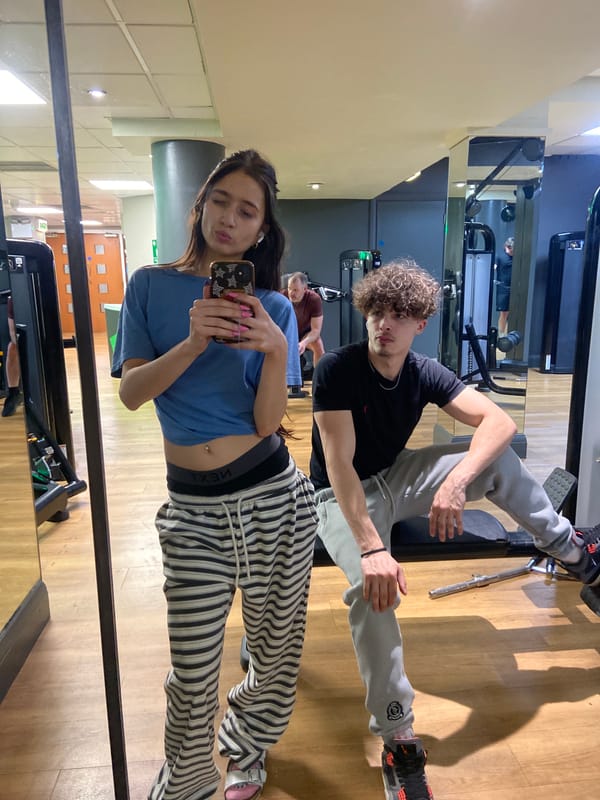 Woman takes gym selfie in London fitness center mirror